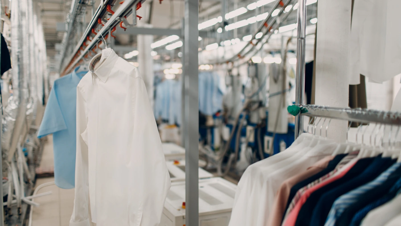 Freshly cleaned garments on a professional dry cleaning rack